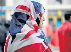  ??  ?? Gulnar Bano Kham Ghadri decided to wear a Union flag headscarf at a Manchester vigil