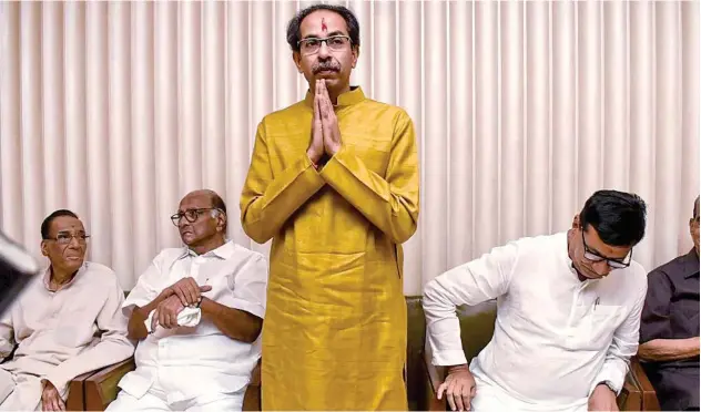  ?? Agence France-presse ?? ↑
Uddhav Thackeray greets legislator­s after he was elected as a leader for the meeting of Congress, NCP and Shiv Sena in Mumbai on Tuesday.