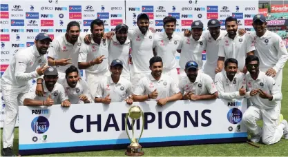  ??  ?? DHARAMSALA: Indian team poses with the Border-Gavaskar Trophy after winning the Test cricket series against Australia in Dharamsala, India, yesterday. India won the four-match series 2-1. — AP