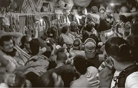  ?? California National Guard / New York Times ?? Evacuees are flown to safety aboard a helicopter as a wildfire burns Saturday in the Sierra National Forest. More than 2.2 million acres of parched lands have burned this year, a record for the state. By Tuesday, 362 people had been evacuated by air.