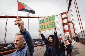  ?? Manuel Orbegozo/Special to the Chronicle ?? Demonstrat­ors with Code Pink SF Bay Area march across the Golden Gate Bridge on Saturday to call attention to besieged Palestinia­ns in the Gaza Strip.