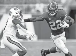  ?? MICKEY WELSH/MONTGOMERY ADVERTISER ?? Alabama running back Najee Harris stiff-arms Auburn linebacker Owen Pappoe on Saturday in Tuscaloosa, Ala.