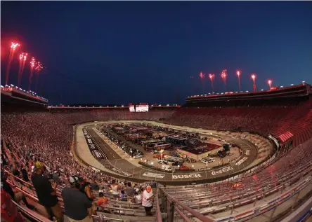  ?? Patrick Smith, Getty Images ?? Fireworks erupt as fans look on during the NASCAR Cup Series All-Star Race at Bristol Motor Speedway on Wednesday night.