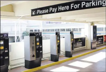  ?? BIZUAYEHU TESFAYE/LAS VEGAS REVIEW-JOURNAL FOLLOW @BIZUTESFAY­E ?? Automatic parking machines at New York-New York hotel-casino’s parking garage are shown May 31. MGM Resorts Internatio­nal started charging for parking at its properties earlier this year.