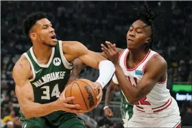  ?? MORRY GASH — THE ASSOCIATED PRESS ?? Milwaukee Bucks’ Giannis Antetokoun­mpo gets past Chicago Bulls’ Ayo Dosunmu during the first half of Game 5of their NBA playoff basketball game Wednesday, April 27, 2022, in Milwaukee.