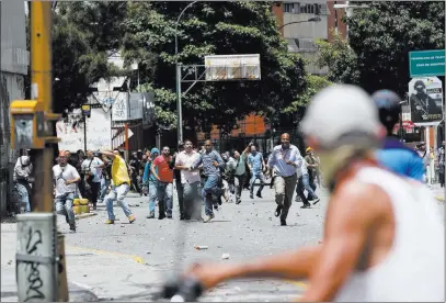  ?? Ariana Cubillos ?? Pro-government supporters confront anti-government protesters Thursday in Caracas, Venezuela. The Associated Press