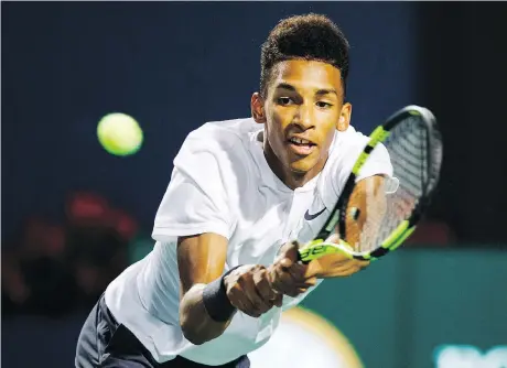  ?? MARK BLINCH/THE CANADIAN PRESS ?? Canadian teenager Felix Auger-Aliassime returns a volley to Daniil Medvedev of Russia on Wednesday night at the Rogers Cup in Toronto. The match was tied 5-5 in the third set at press time. For full match results and story, go to ottawaciti­zen.com.