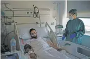  ?? AP PHOTO/FELIPE DANA ?? A COVID-19 patient receives treatment Friday in the Hospital del Mar in Barcelona, Spain.
