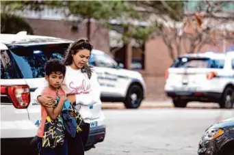  ?? Billy Schuerman/Virginian-Pilot ?? Joselin Glover escorts her 9-year-old son, Carlos Glover, a fourth-grader at Richneck Elementary School, from the school after a shooting injured a teacher Friday in Newport News, Va.