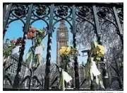  ?? JUSTIN TALLIS/GETTY-AFP ?? Tributes to victims of last week’s London terror attack remain Monday outside the Parliament building.