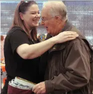  ??  ?? Quilts of Valour Canada representa­tive Marcie Erick presents a quilt to Swift Current veteran Peter Rymes.