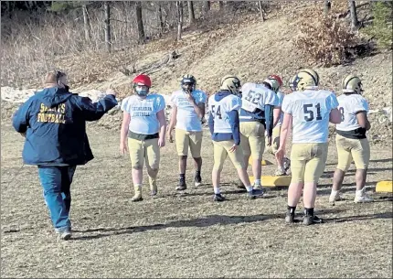  ?? NICK MALLARD / SENTINEL & ENTERPRISE ?? St. Bernard’s head coach Tom Bingham, left, instructs players during Friday afternoon’s practice.