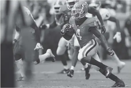  ?? AP PHOTO/JOSHUA L. JONES ?? Georgia wide receiver Mecole Hardman breaks loose on a kickoff return during the first half of Saturday’s game against Middle Tennessee in Athens, Ga.