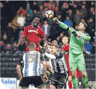  ??  ?? County’s Adam Collin clears from Wilfried Bony