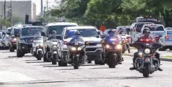  ?? Houston Chronicle via AP ?? n The body of Harris County Precinct 3 Assistant Chief Deputy Clinton Greenwood is escorted to the Harris County Institute of Forensic Sciences on Mondain Houston. Greenwood died after he was shot moments after arriving for work in Baytown, Texas.