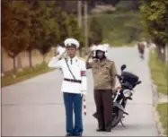  ?? ANDREW HARNIK — THE ASSOCIATED PRESS ?? Members of the North Korean military salute the motorcade carrying U.S. Secretary of State Mike Pompeo as it makes its way to the Park Hwa Guest House in Pyongyang, North Korea, Friday. Pompeo is on a trip traveling to North Korea, Japan, Vietnam, Abu Dhabi, and Brussels.