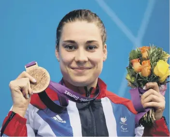  ?? ?? Swimmer Harriet Lee proudly shows off the bronze medal she wonat the 2012 Paralympic­s.