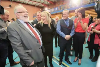  ?? — AFP ?? Sinn Fein’s Michelle O’Neill (2L) celebrates with colleagues after winning her seat at the Mid-Ulster count for the Northern Ireland Assembly elections in Ballymena, Co Antrim, Northern Ireland, on Friday.