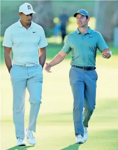  ??  ?? Tiger Woods and Rory McIlroy walk across the 17th hole during the second round of the Genesis Open at Riviera Country Club - AFP