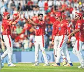  ??  ?? Kings XI Punjab team captain and bowler Ravichandr­an Ashwin (C) celebrates during his team’s match against Delhi Daredevils.