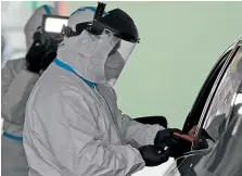  ?? AP ?? A person’s blood is collected for testing of coronaviru­s antibodies at a drive-through testing site in Hempstead, New York.