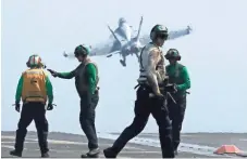  ?? BULLIT MARQUEZ, AP ?? A fighter jet takes off from the aircraft carrier USS Carl Vinson for a patrol of the disputed South China Sea on Friday. China and other nations are clashing over ownership of the sea.