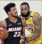  ?? Mark J. Terrill / Associated Press ?? Heat forward Jimmy Butler drives around Lakers forward Lebron James in the second half Tuesday.