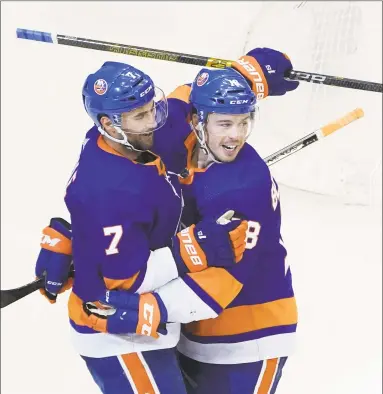  ?? Andre Ringuette/Freestyle Photo / Getty Images ?? The Islanders’ Jordan Eberle (7) celebrates with teammate Anthony Beauvillie­r after scoring a goal against the Panthers during the third period on Tuesday in Toronto.