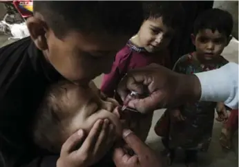  ?? K.M. CHAUDARY/THE ASSOCIATED PRESS ?? Polio continues to be endemic in Pakistan, where vaccines are viewed with suspicion by some. A Human Rights Watch report says that militant groups, including the Pakistani Taliban, targeted anti-polio health centres in 2014.