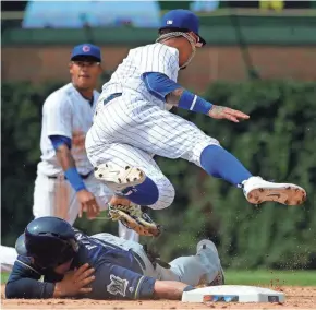  ?? ASSOCIATED PRESS ?? Brewers catcher Manny Piña injured his left shoulder diving back into second base against the Cubs on Wednesday.