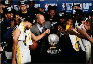  ?? AP PHOTO BY DAVID J. PHILLIP ?? The Golden State Warriors pose with their trophy after defeating the Houston Rockets in Game 7 of the NBA basketball Western Conference finals, Monday, May 28, in Houston.