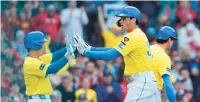  ?? MICHAEL DWYER/AP ?? Boston Red Sox’s Triston Casas, right, celebrates after his two-run home run that also drove in Masataka Yoshida, left, during the first inning against the Los Angeles Angels on Saturday.