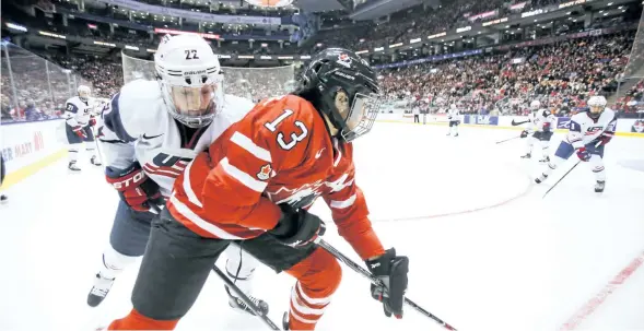 ?? ERNEST DOROSZUK/TORONTO SUN FILES ?? Team Canada’s Caroline Ouellette battles with Team USA’s Kacey Bellamy in this 2013 file photo.