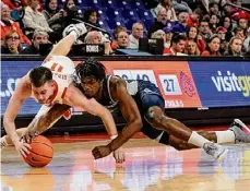 ?? Mike Stewart/associated Press ?? Clemson guard Joe Girard III vies for a loose ball against Queens University guard AJ Mckee during the first half on Friday in Clemson, S.C.