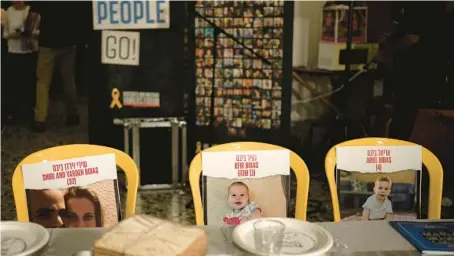  ?? MAYA ALLERUZZO/AP ?? Chairs at a Passover Seder table are set April 11 at Kibbutz Nir Oz in southern Israel for members of the Bibas family held hostage in Gaza.