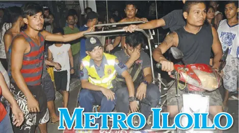  ?? IAN PAUL CORDERO/PN ?? Warren Alinsubao (seated, right) covers his face as a police officer escorts him to the police station in La Paz, Iloilo City via a tricycle on Wednesday, June 13. He was accused of groping of a teenaged girl while on a public utility jeepney.