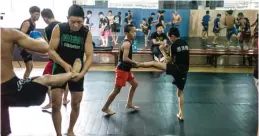  ??  ?? CHENGDU: This picture taken on June 2, 2017 shows youth practising mixed martial arts (MMA) during a training session at the Enbo Fight Club in Chengdu. — AFP