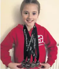  ??  ?? Gymnast Ava Randles with some of her medals