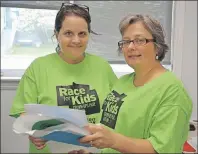  ?? ELIZABETH PATTERSON/CAPE BRETON POST ?? Organizers of this year’s Race for Kids Fundraiser, Rayanne Rogers, left, and Pam Petrie, check out some last-minute details for this year’s event, which took place at the Whitney Pier Youth Club on Saturday.