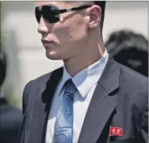  ?? Andrew Harnik Associated Press ?? A NORTH Korean security officer in Washington on June 1 wears a pin showing Kim Jong Un’s father and grandfathe­r.