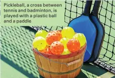  ??  ?? Pickleball, a cross between tennis and badminton, is played with a plastic ball and a paddle
