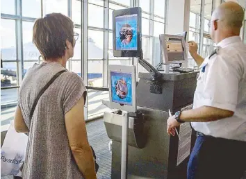  ?? AFP ?? A woman boarding a SAS flight to Copenhagen goes through facial recognitio­n verificati­on system VeriScan at Dulles Internatio­nal Airport in Virginia on Thursday.