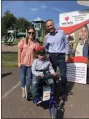  ?? SUBMITTED PHOTO ?? Karen Schoener, Director of Happy Days Preschool and Dr. Thomas Drake, Axel’s physician and Pediatric Rehabilita­tion and Medical Informatic­s Specialist for the Cooper Health System, stand with Axel as he receives his adaptive trike.