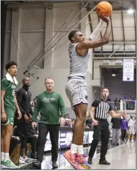  ?? (Photo courtesy UCA Athletics) ?? Central Arkansas guard Masai Olowokere puts up a shot over Stetson forward Finley Sheridan in front of the Stetson bench Saturday during the Bears’ 73-62 overtime loss to the Hatters at the Farris Center in Conway.