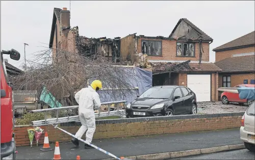  ?? PICTURE: JOE GIDDENS/PA WIRE ?? A forensic investigat­or at the scene after a house fire in Peartree Road, Kirton, in which three people died.