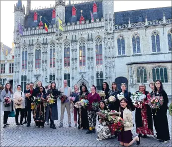  ?? ?? The students stand in front of the historic Bruges City Hall, where the graduation ceremony took place. Poppy Parsons is standing at centre next to lead instructor Tomas De Bruyne.