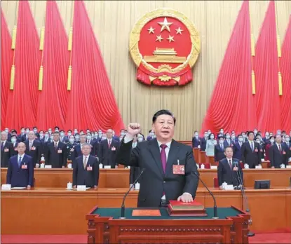  ?? JU PENG / XINHUA ?? Xi Jinping, newly elected president of the People’s Republic of China and chairman of the Central Military Commission of the PRC, makes a public pledge of allegiance to the Constituti­on at the Great Hall of the People in Beijing on March 10.