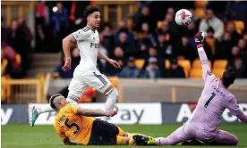  ?? Photograph: Ed Sykes/ Action Images/Reuters ?? Rodrigo scores the fourth goal for Leeds past Wolves' José Sá.