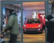  ?? Sean Gallup Getty I mages ?? TESLA delivered 499,500 vehicles last year, including 180,570 in the October- through- December period.