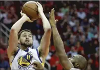  ?? The Houston Chronicle/tns ?? Golden State Warriors guard Klay Thompson takes a shot over Houston Rockets guard Chris Paul during the fourth quarter of an NBA basketball game at Toyota Center on March 13 in Houston.